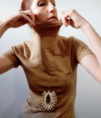 Tupak pendant. Gold and silver coloured leather